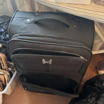 Sale Photo Thumbnail #166: Black Jeep brand rolling softside suitcase with multiple zippered exterior compartments.
