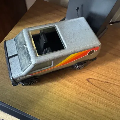 Sale Photo Thumbnail #293: Vintage Tonka pressed steel custom van toy in silver with red and orange side stripes, circa 1970s.
