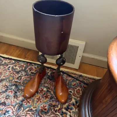Sale Photo Thumbnail #38: Whimsical novelty umbrella stand crafted from a dark brown cylindrical bucket supported by wooden shoe tree legs.