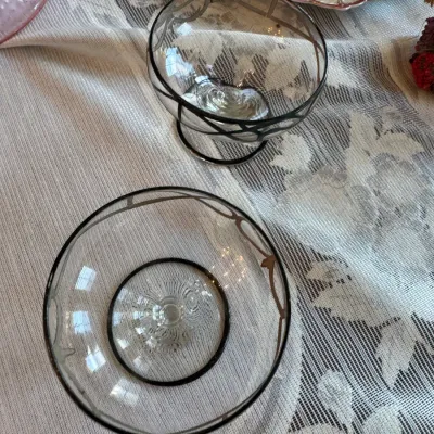 Sale Photo Thumbnail #416: Pair of vintage clear glass dessert bowls featuring silver overlay filigree trim along the rims and base.