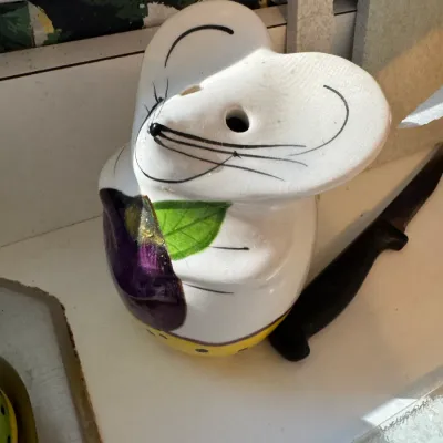 Sale Photo Thumbnail #263: Whimsical ceramic mouse-shaped kitchen holder or sponge caddy with hand-painted details and an eggplant motif.