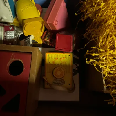 Sale Photo Thumbnail #91: Assortment of vintage plastic and wooden children's toys, including a Fisher-Price music box radio and shape sorters.