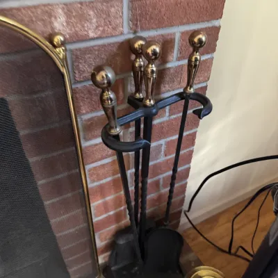 Sale Photo Thumbnail #288: Wrought iron and polished brass fireplace tool set, including a stand, shovel, broom, poker, and tongs.