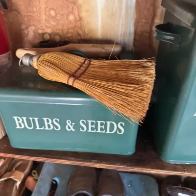 Sale Photo Thumbnail #24: Vintage green metal garden storage tin labeled 'BULBS & SEEDS' with a whisk broom resting on top.