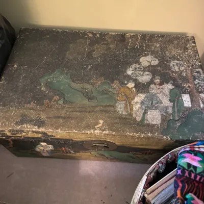 Sale Photo Thumbnail #52: Antique Asian painted wooden storage chest featuring hand-painted figures in a landscape setting with heavy surface wear and brass hardware.