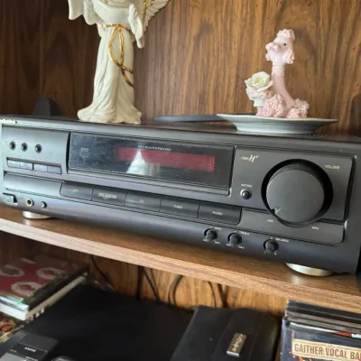 Sale Photo Thumbnail #305: Technics Class H+ stereo receiver resting on a wooden shelf alongside ceramic figurines.