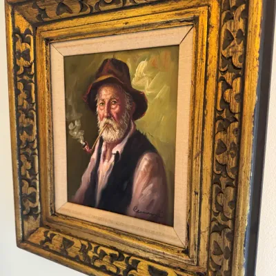 Sale Photo Thumbnail #46: Framed oil painting portrait of an elderly bearded man smoking a pipe, housed in an ornate carved gilt wood frame with a fabric liner.