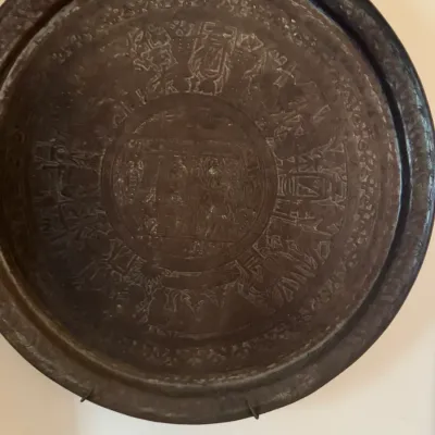 Sale Photo Thumbnail #318: Large brass wall plaque with intricate etched hieroglyphic motifs and figures, mounted for hanging.