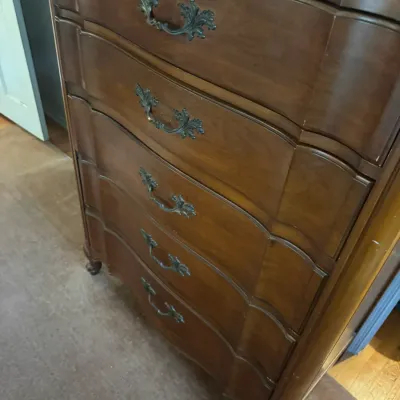 Sale Photo Thumbnail #183: French Provincial style five-drawer tallboy chest in a dark cherry finish, featuring serpentine drawer fronts and ornate metal hardware.