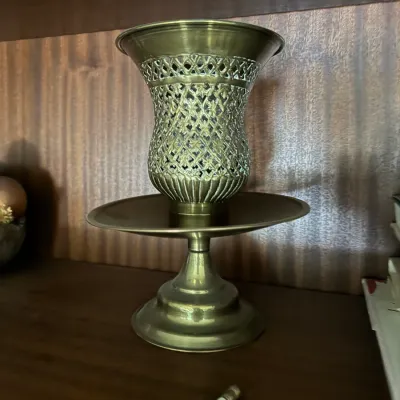 Sale Photo Thumbnail #112: Vintage brass pedestal hurricane lamp or incense burner featuring an ornate pierced lattice body atop a round tray base.