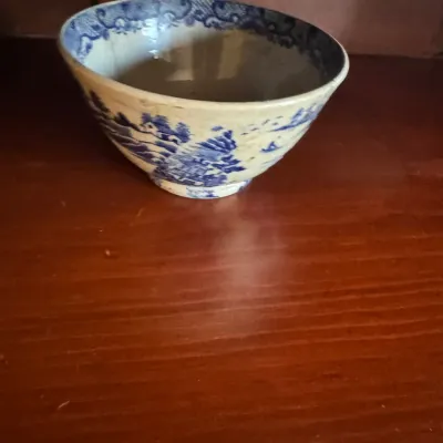 Sale Photo Thumbnail #405: Antique blue and white transferware porcelain bowl featuring a traditional landscape scene.