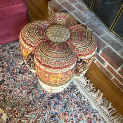 Sale Photo Thumbnail #36: Four-lobed upholstered ottoman featuring tapestry-style fabric with elephant motifs, rope trim, and tassels.