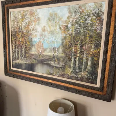 Sale Photo Thumbnail #283: Large vintage Impressionist-style oil painting depicting a forest landscape with birch trees and a quiet stream, set in an ornate carved wooden frame with gold trim.