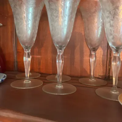 Sale Photo Thumbnail #392: Set of vintage etched crystal champagne flutes featuring delicate floral rose patterns.