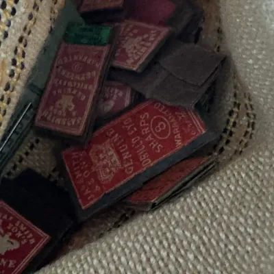 Sale Photo Thumbnail #366: Collection of vintage James Smith & Sons sewing needle paper packets stored inside a woven pouch.