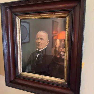 Sale Photo Thumbnail #47: Framed portrait print of a gentleman in formal attire, presented in a dark molded wooden frame with a gilded inner border.