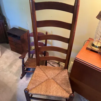 Sale Photo Thumbnail #344: Vintage Shaker-style ladder-back chair with a woven rush seat and tall turned finials.