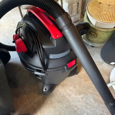 Sale Photo Thumbnail #198: Craftsman wet/dry shop vacuum in black and red plastic, complete with attached hose and power cord.