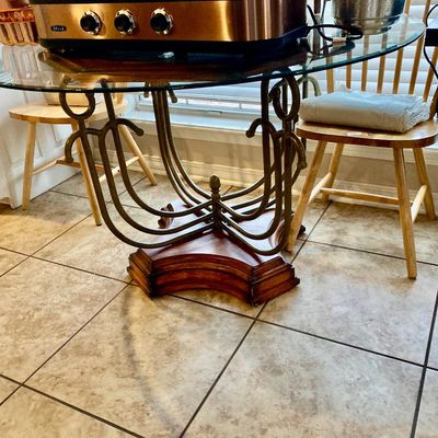 Sale Photo Thumbnail #71: Round glass top dining table with ornate scrolling legs and wood base