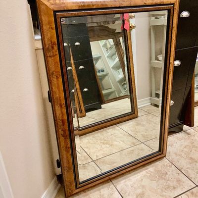 Sale Photo Thumbnail #260: Large rectangular wall mirror featuring a burl wood style frame with dark inner trim detailing.