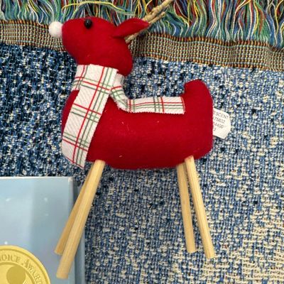 Sale Photo Thumbnail #178: 11 piece Christmas set for throw blankets one new hand towel three books one reindeer ornament one merry Christmas bag one wine stopper. All in perfect condition blankets measure approximately. 1 72x57 and 3 at 65x44.