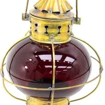 Sale Photo Thumbnail #19: Vintage brass maritime lantern featuring a deep red glass globe and protective wire cage.