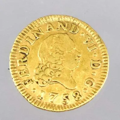 Sale Photo Thumbnail #10: 1758 Spanish Ferdinand VI gold coin featuring a right-facing bust profile and raised lettering along the border.