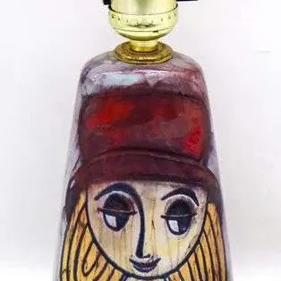 Sale Photo Thumbnail #18: Mid-century modern ceramic table lamp base featuring a hand-painted stylized portrait of a woman.