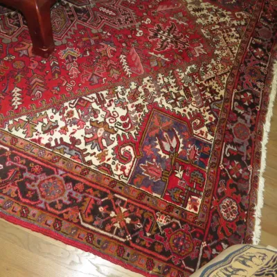 Sale Photo Thumbnail #34: Hand-knotted tribal Persian or Caucasian area rug featuring intricate geometric motifs in shades of red, cream, navy blue, and dark brown, finished with white fringed edges.