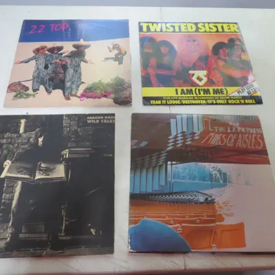 Sale Photo Thumbnail #90: Collection of four vintage vinyl rock albums, including ZZ Top's El Loco, Twisted Sister's I Am (I'm Me), Graham Nash's Wild Tales, and Joni Mitchell's Miles of Aisles.
