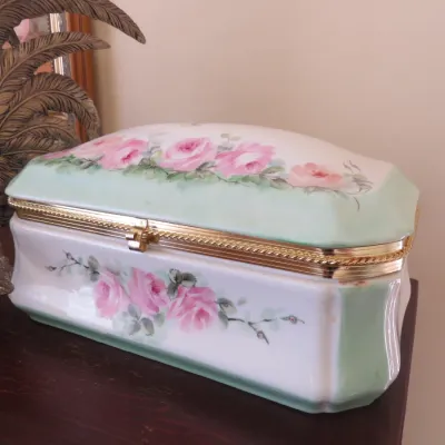 Sale Photo Thumbnail #13: Hand-painted porcelain trinket box featuring pink roses, pale green trim, and a gilt metal hinged rim.