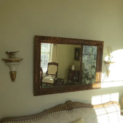 Sale Photo Thumbnail #8: Large rectangular wall mirror with a ornate gilt frame, flanked by a pair of matching decorative wall sconce shelves.