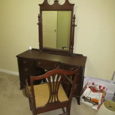 Sale Photo Thumbnail #81: Traditional mahogany vanity set featuring a broken-arch pediment mirror with finial and a matching splat-back chair with upholstered seat.