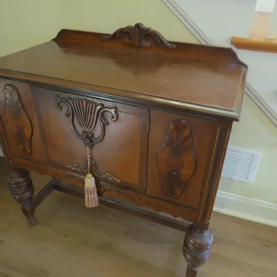 Sale Photo Thumbnail #19: Antique Jacobean Revival dark wood server or buffet with ornate carved details, turned legs, and a hanging tassel key.