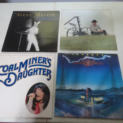 Sale Photo Thumbnail #132: Group of four vintage 33 RPM vinyl LP records, including Steve Martin's "A Wild and Crazy Guy", Carl Perkins, the "Coal Miner's Daughter" soundtrack, and Journey's "Raised on Radio".