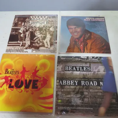 Sale Photo Thumbnail #114: Collection of four vintage vinyl LP record albums featuring Alice Cooper, Glen Campbell, and two Beatles albums, including 'Love' and 'Abbey Road'.