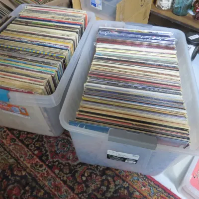 Sale Photo Thumbnail #149: Two clear plastic storage totes filled with a large collection of vintage vinyl LP records in their original sleeves.