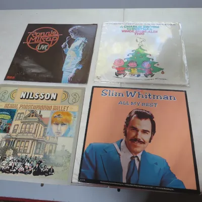 Sale Photo Thumbnail #116: Collection of four vintage vinyl LP albums, including titles by Ronnie Milsap, Vince Guaraldi Trio, Nilsson, and Slim Whitman.