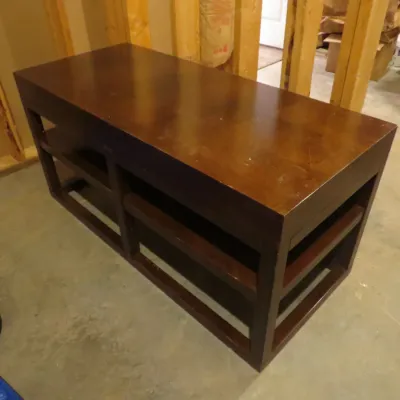 Sale Photo Thumbnail #59: Dark wood modern coffee table or bench with open lower shelving, showing light surface wear.