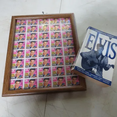 Sale Photo Thumbnail #146: Framed full sheet of 1993 USPS 29-cent Elvis Presley commemorative stamps alongside an Elvis Presley Paperback Songs songbook by Hal Leonard.