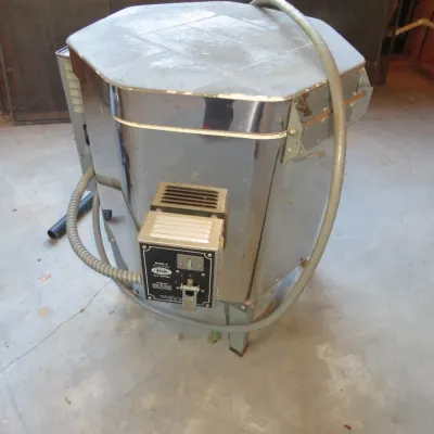 Sale Photo Thumbnail #52: Vintage Skutt electric ceramic kiln with a metallic jacket, attached control unit, and power cord, showing light surface wear.