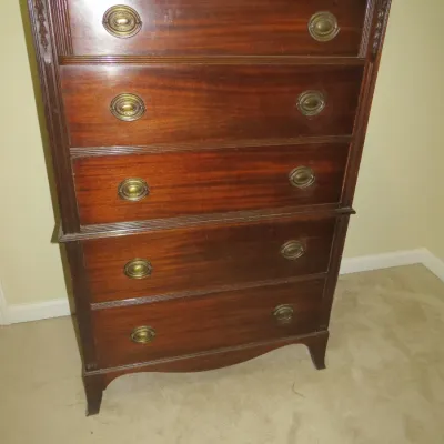 Sale Photo Thumbnail #82: Traditional mahogany tallboy chest of drawers featuring brass oval bail handles and fluted trim detail.