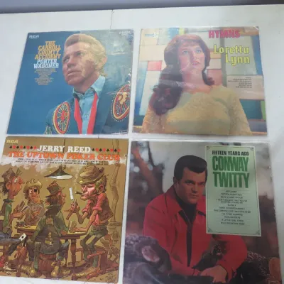 Sale Photo Thumbnail #128: Collection of four vintage country music vinyl LP albums, featuring artists Porter Wagoner, Loretta Lynn, Jerry Reed, and Conway Twitty.