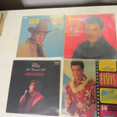 Sale Photo Thumbnail #138: Collection of four vintage Elvis Presley vinyl LP records, including "Flaming Star," "Girl Happy," "He Touched Me," and "Blue Hawaii."