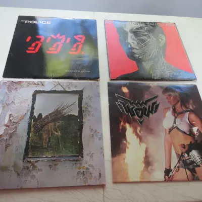 Sale Photo Thumbnail #91: Collection of four vintage rock vinyl LP albums, including The Police's Ghost in the Machine, The Rolling Stones' Tattoo You, Led Zeppelin IV, and Wendy O. Williams' WOW.