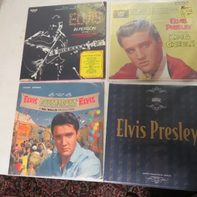 Sale Photo Thumbnail #141: Group of four Elvis Presley vinyl LP record albums, including 'In Person at the International Hotel', 'King Creole', 'Roustabout', and a USPS Commemorative Edition.