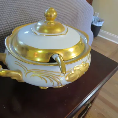 Sale Photo Thumbnail #30: Vintage white porcelain tureen with heavy gilt trim, lid, and matching ladle, in good condition with minor wear to the gilding.