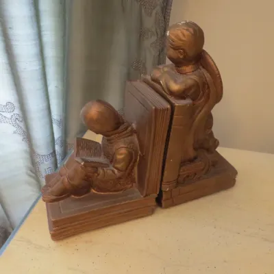 Sale Photo Thumbnail #87: Pair of vintage bronze-tone chalkware or composite bookends depicting children reading, showing minor paint wear.