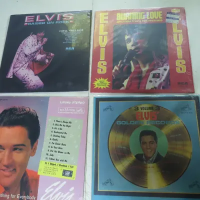 Sale Photo Thumbnail #144: Collection of four Elvis Presley vinyl LP record albums, including 'Raised on Rock', 'Burning Love', 'Something for Everybody', and 'Elvis' Golden Records Volume 3'.