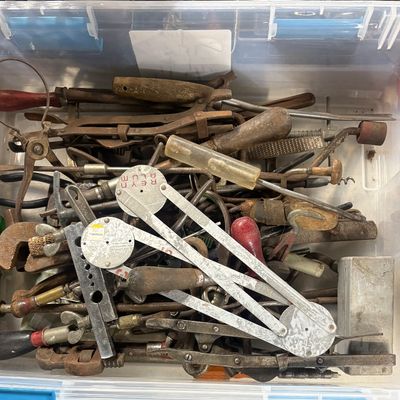 Sale Photo Thumbnail #84: Clear plastic storage bin filled with an assortment of vintage hand tools, including calipers, files, screwdrivers, and pipe wrenches.
